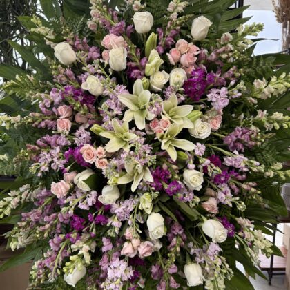 Healing Memories Funeral Spray - Comforting Design featuring white lilies, roses, and purple stock in a lush arrangement.