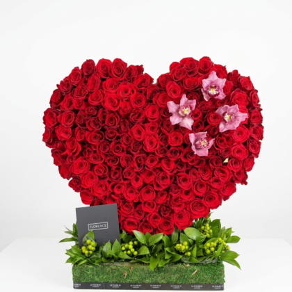 One in a Million - Standing Heart features vibrant red roses and delicate pink orchids, elegantly arranged in a heart shape.