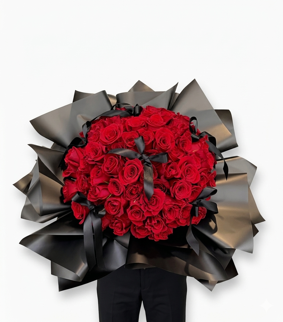 Sposa Serena - Wrapped Bouquet features luxurious red roses elegantly arranged with black satin ribbons.
