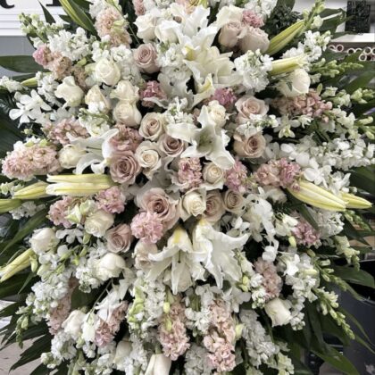 Sacred Memories Funeral Spray - Profound Elegance featuring white lilies, dusty pink roses, and white stock flowers.