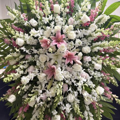 Silent Garden Funeral Spray - Vibrant Tribute featuring white roses, pink lilies, and snapdragons in an elegant arrangement.