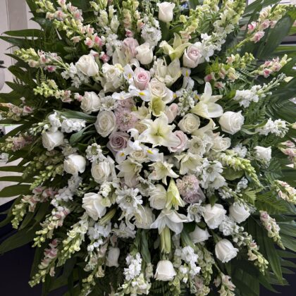 Everly Ever After funeral spray featuring white roses, lilies, and snapdragons, an Elegant Tribute like Winter Grace.