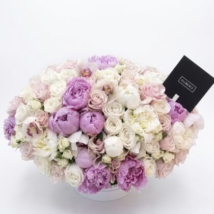 Luxurious arrangement of soft pink and lavender peonies, complemented by delicate white roses, exuding elegance.