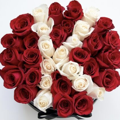 An elegant arrangement of deep red and creamy white roses, beautifully crafted for a luxurious touch.