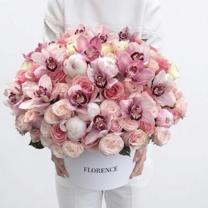 A luxurious arrangement of pink roses, peonies, and orchids in a premium white box, exuding elegance.