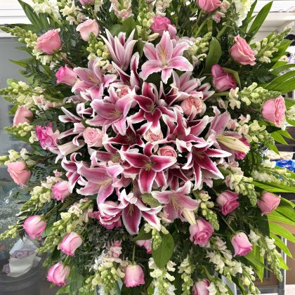Velvet Petals Funeral Spray - Breathtaking Floral Tribute featuring pink lilies, roses, and white snapdragons.
