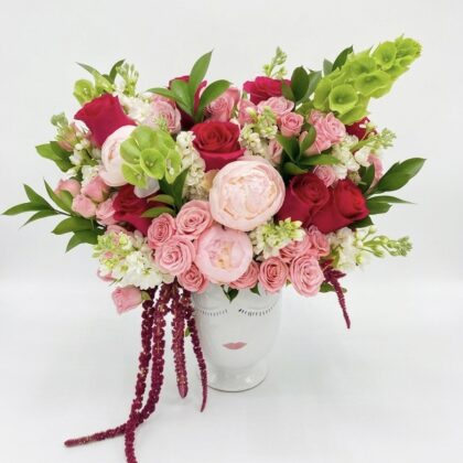 Luxurious Coeur De Sucre - Ceramic Vase filled with vibrant pink and red roses, peonies, and delicate greenery.