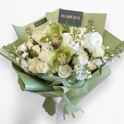 Signorina Dolce - Wrapped Bouquet featuring elegant white roses, delicate orchids, and lush greenery.