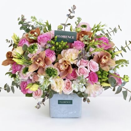Elegant Positano Sole - Concrete Vase filled with vibrant pink roses, orchids, and lush greenery.