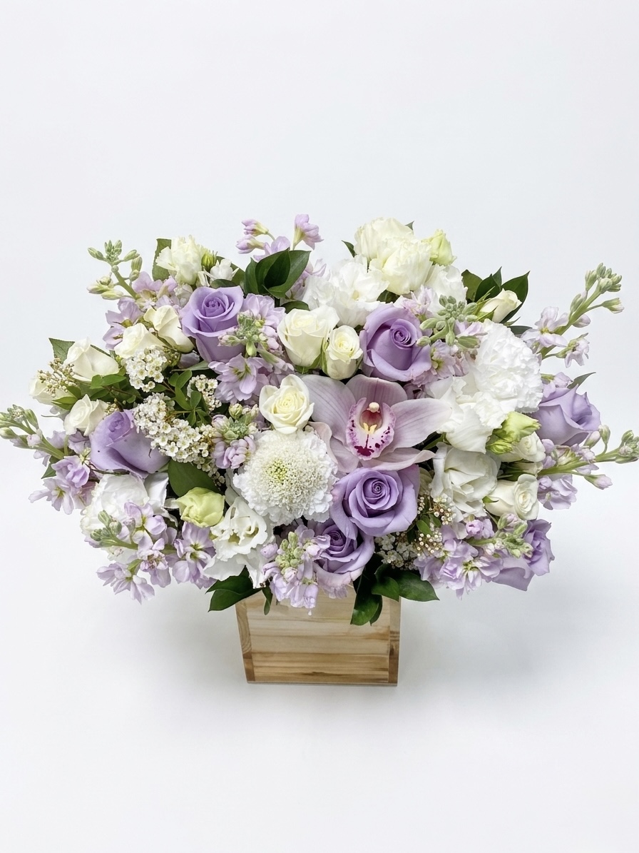 An elegant arrangement of lavender roses, white orchids, and delicate blooms in a luxurious display.