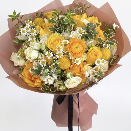 A luxurious bouquet featuring vibrant yellow roses, delicate white daisies, and lush greenery, elegantly arranged.