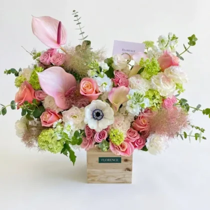 Bonjour Belle – Contemporary Ceramic Vase featuring pink anthuriums, roses, and white anemones in a wooden box.