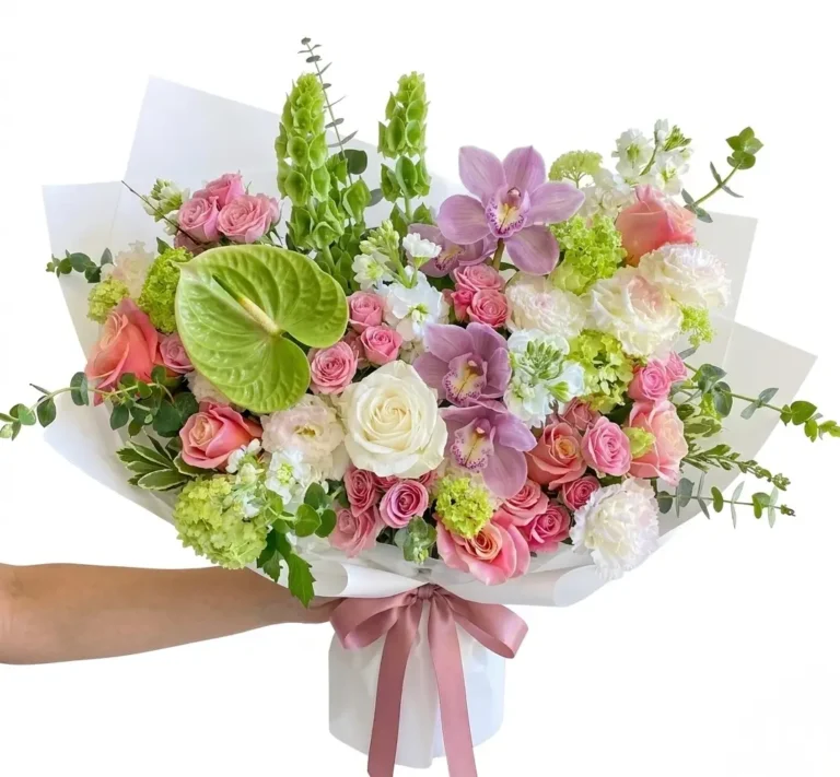 Maison De Beaute &ndash; Exquisite Wrapped Bouquet featuring pink roses, orchids, and green anthurium in white paper.