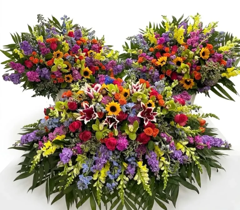 Three opulent floral arrangements featuring vibrant sunflowers, lilies, roses, and snapdragons in a lush, colorful display.