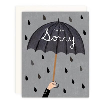 A hand holding a black umbrella on a gray background with rain, perfect for I'm So Sorry Cute Cards for Heartfelt Apologies.
