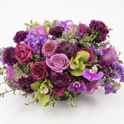 Sucre De Violette – Luxurious Floral Vase featuring deep purple roses, orchids, and scabiosa in a dense arrangement.