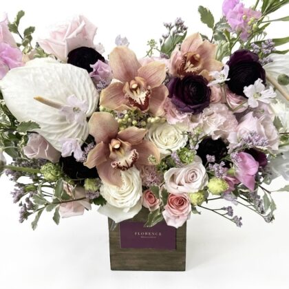 Bisou De Velours – Contemporary Floral Design featuring orchids, roses, and anthuriums in a wooden pot.