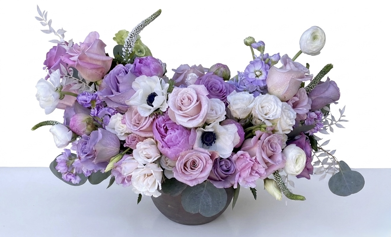 Jolie Plumage - Ceramic Vase adorned with elegant lavender and white roses, complemented by delicate greenery.