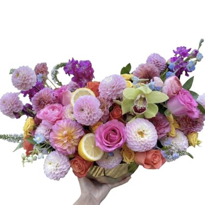 Coco Cherie – Vibrant Floral Masterpiece featuring dahlias, roses, and orchids in a gold ceramic vase.