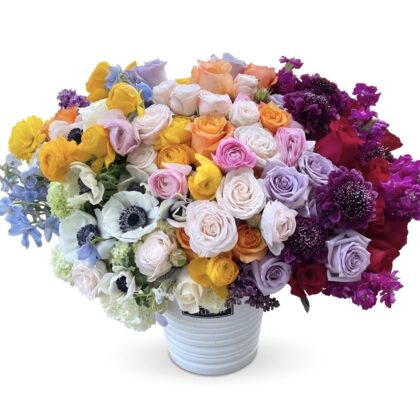 La Vie En Fleur – Stunning Ceramic Vase featuring a vibrant, dense arrangement of multicolored roses, anemones, and stock.
