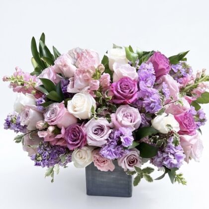 Bebe Jolie &ndash; Elegant Wood Pot Arrangement featuring a lush mix of lavender, pink, and white roses and stock flowers.