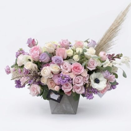 Merci Mon Coeur – Modern Concrete Vase filled with a lush arrangement of pastel pink, lavender, and white flowers.