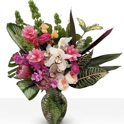 Tropical Luxury L'Exotique Vase Centerpiece featuring pink ginger, white orchids, and lush foliage in a glass vase.