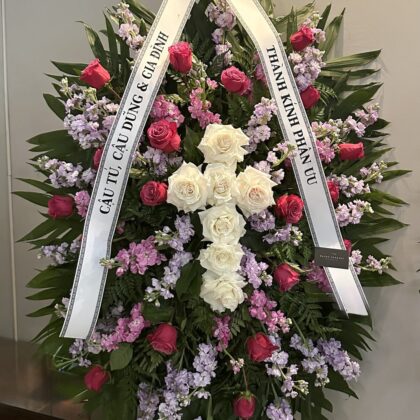 Time After Time Elegant Floral Cross Funeral Spray featuring white roses, pink roses, and lavender stock flowers.