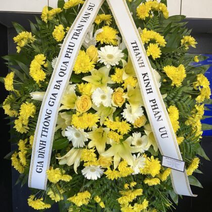 Fondest Farewell – Beautiful Funeral Spray featuring yellow chrysanthemums, white lilies, and gerbera daisies.