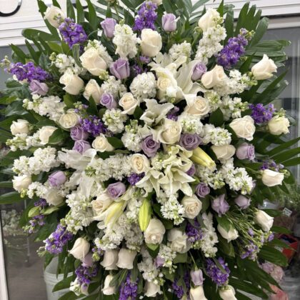 Silver Lining Funeral Spray - Elegant Floral Tribute featuring white roses, lilies, and lavender stock flowers.