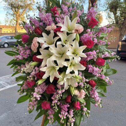 Sweetest Goodbye Funeral Spray - Elegant Floral Design featuring white lilies, pink stock, and deep red roses.
