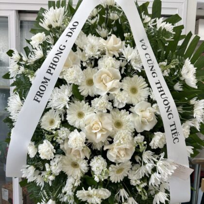 Halo Blooms – Serene Funeral Spray featuring white roses, chrysanthemums, and carnations with elegant ribbon streamers.