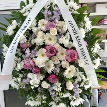 Starry Nights &ndash; Beautiful Funeral Spray featuring white daisies, lavender roses, and purple stock in an elegant arrangement.