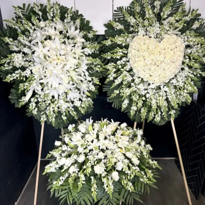 Quiet Blooms Funeral Set featuring elegant white lilies, roses, and snapdragons in a Majestic Tribute arrangement.