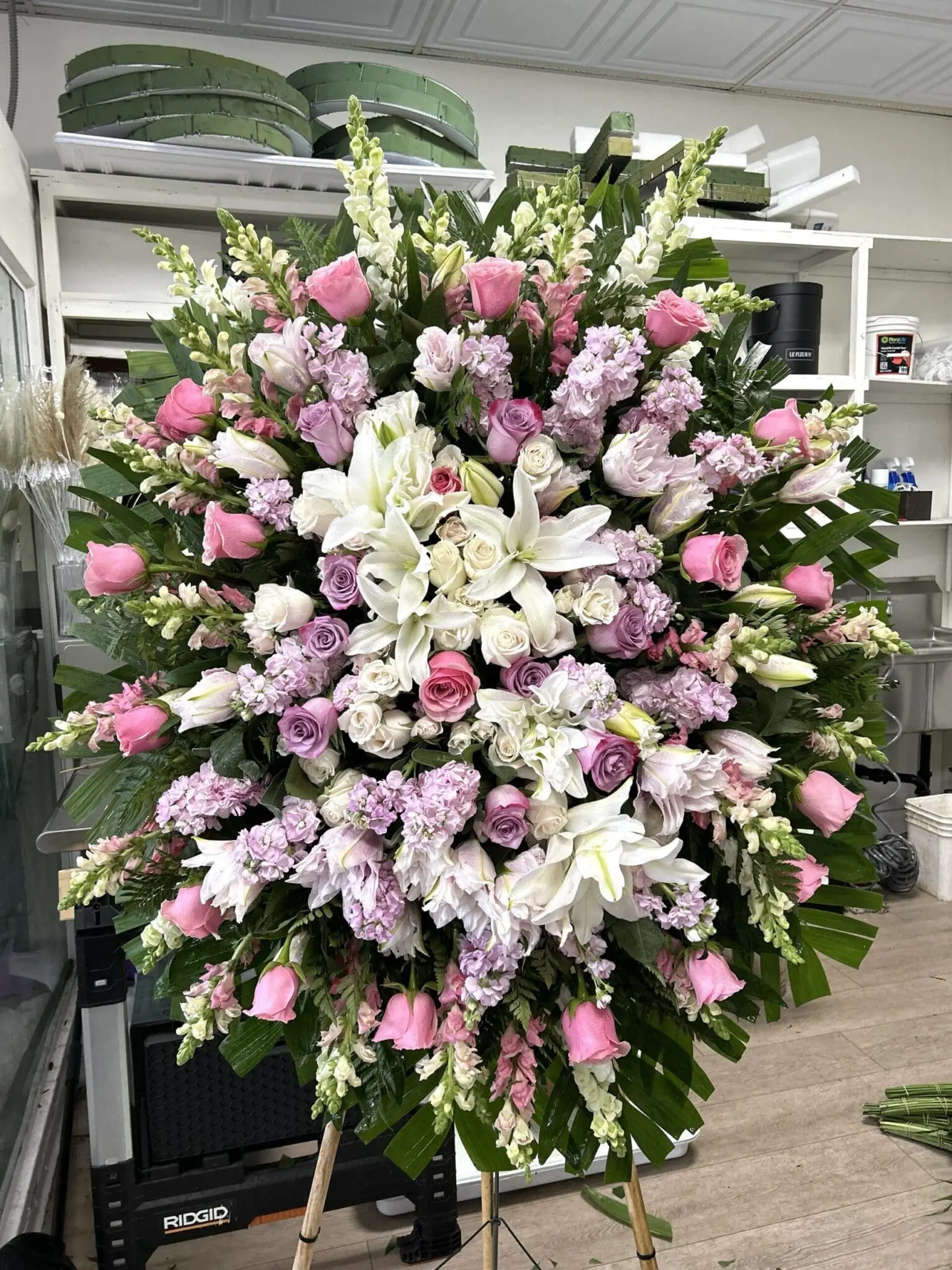 Botanical Memories Funeral Spray - Elegant Design featuring pink roses, white lilies, and lavender stock flowers.