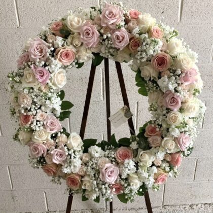 Gentle Journey Wreath - Elegant Funeral Tribute featuring soft pink and cream roses with delicate white baby's breath.