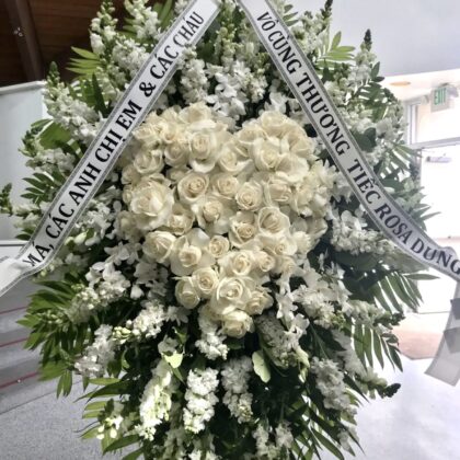 Tender Hearts Funeral Spray - Comforting Tribute featuring a heart of white roses surrounded by white snapdragons.