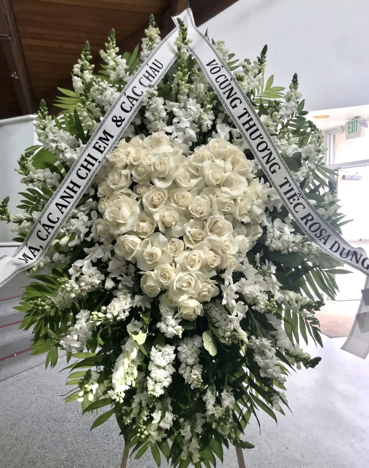 Tender Hearts Funeral Spray - Comforting Tribute featuring a heart of white roses surrounded by white snapdragons.