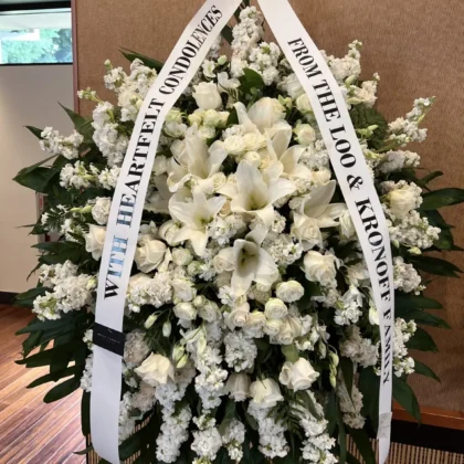Silk & Solace Funeral Spray - Timeless Elegance featuring white lilies, roses, and stock flowers in a lush arrangement.