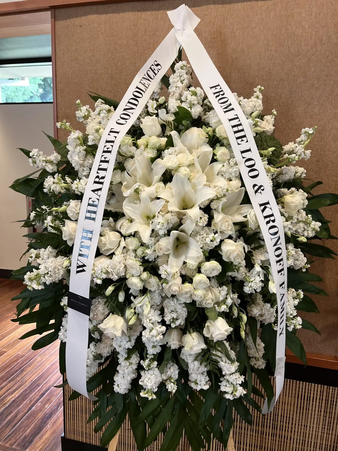Silk & Solace Funeral Spray - Timeless Elegance featuring white lilies, roses, and stock flowers in a lush arrangement.