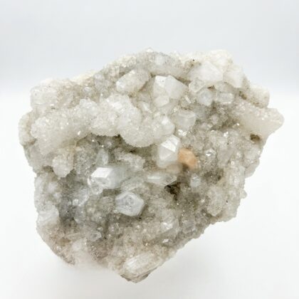 A sparkling white Apophyllite crystal for meditation and mindfulness, featuring geometric points and a soft peach accent.